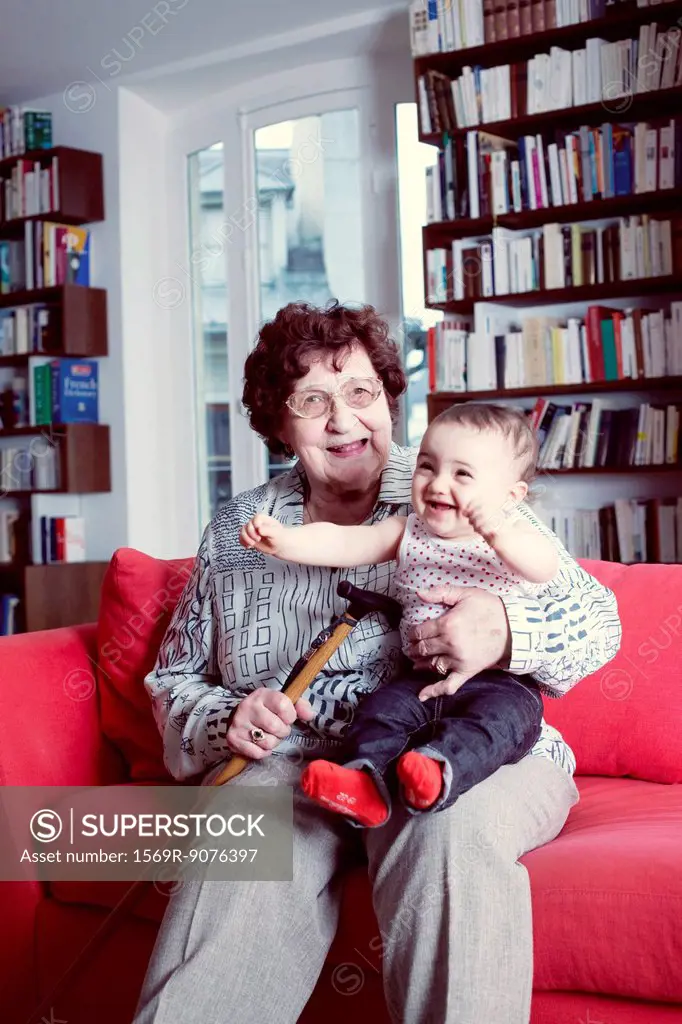 Grandmother holding baby granddaughter, portrait