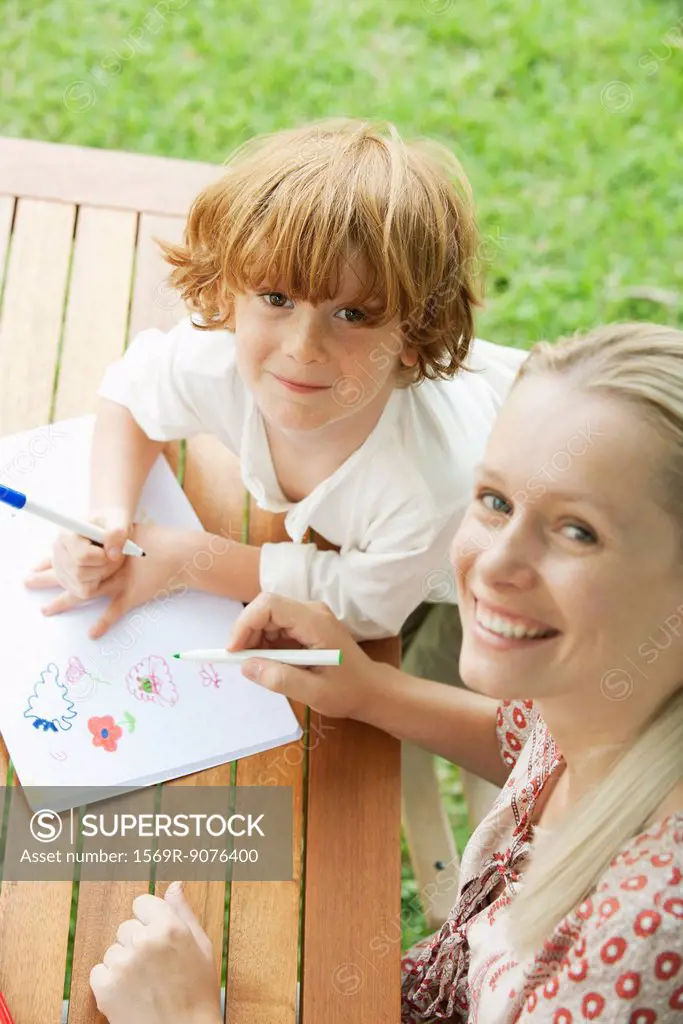 Mother and son coloring together, high angle view