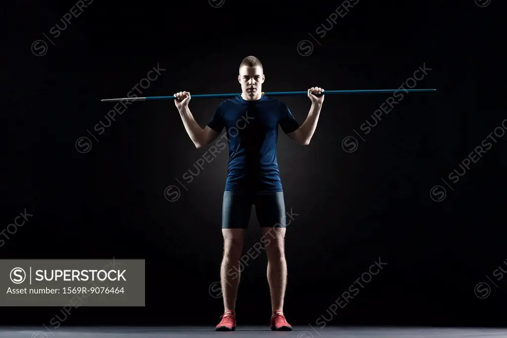 Male athlete standing with javelin