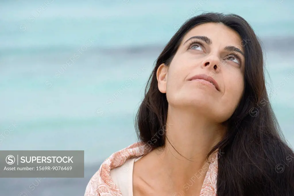 Woman at the beach, looking up