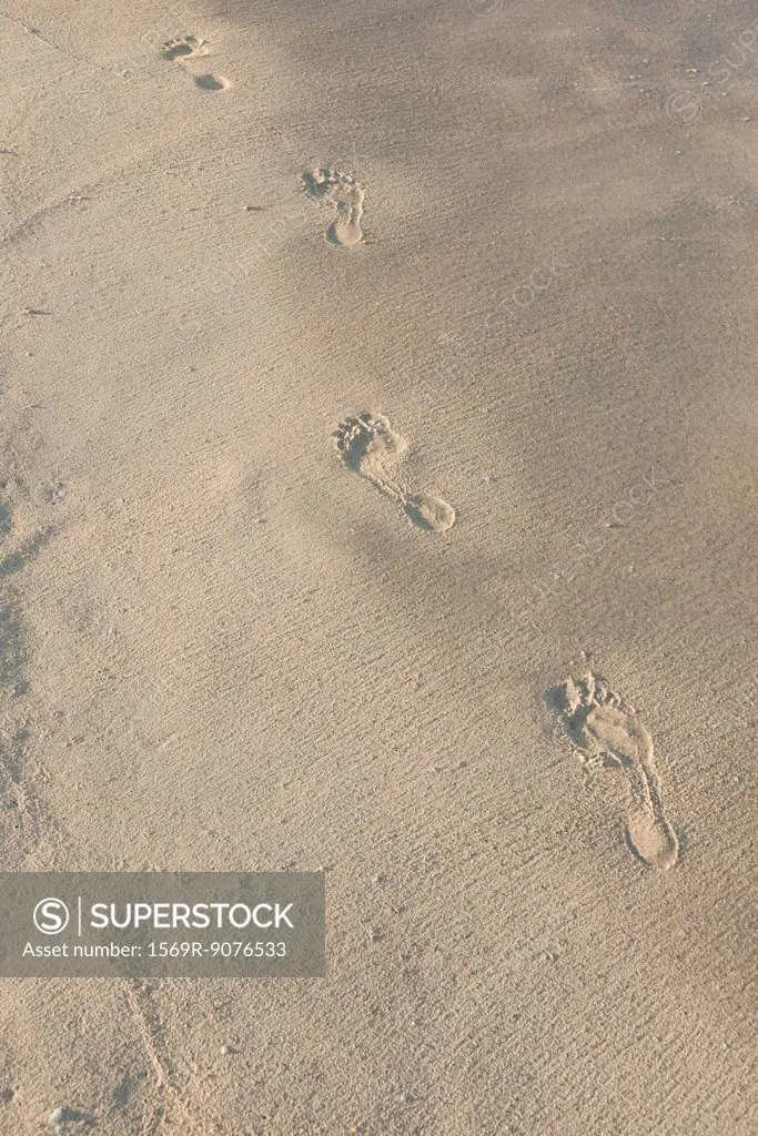 Footprints in sand, high angle view