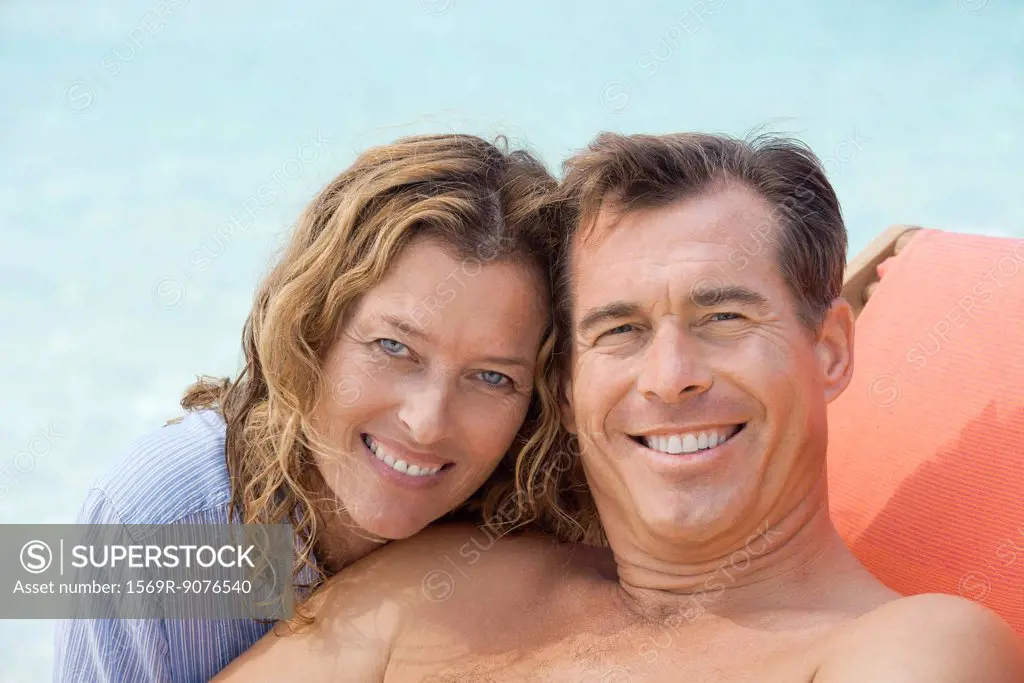 Couple relaxing at beach, portrait