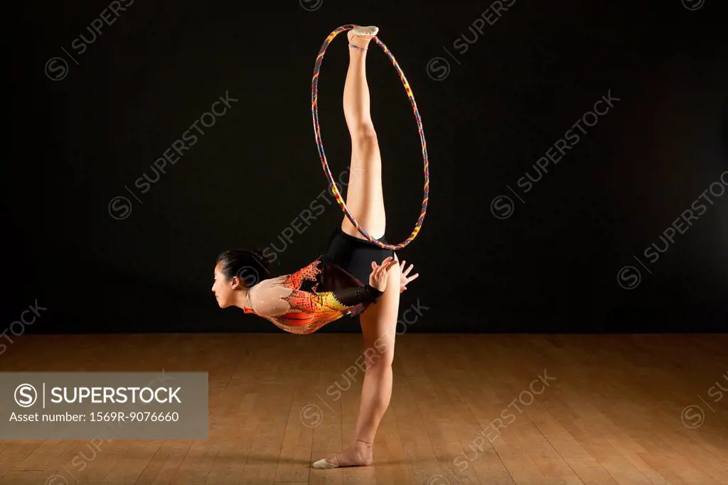 Gymnast performing standing splits with hood