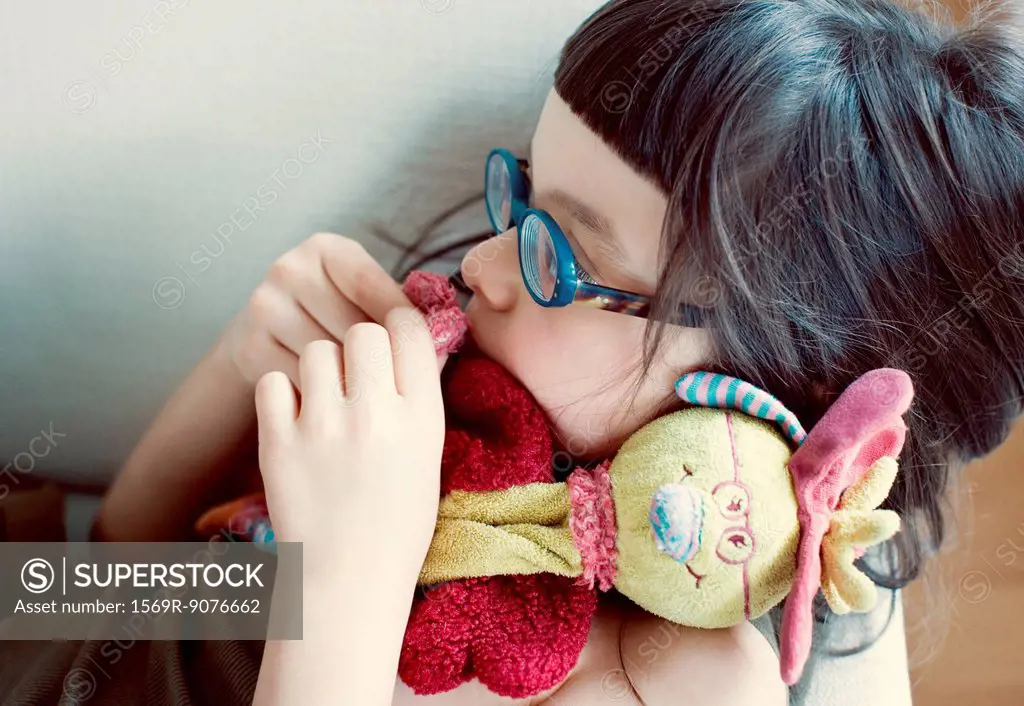 Girl cuddling stuffed toy