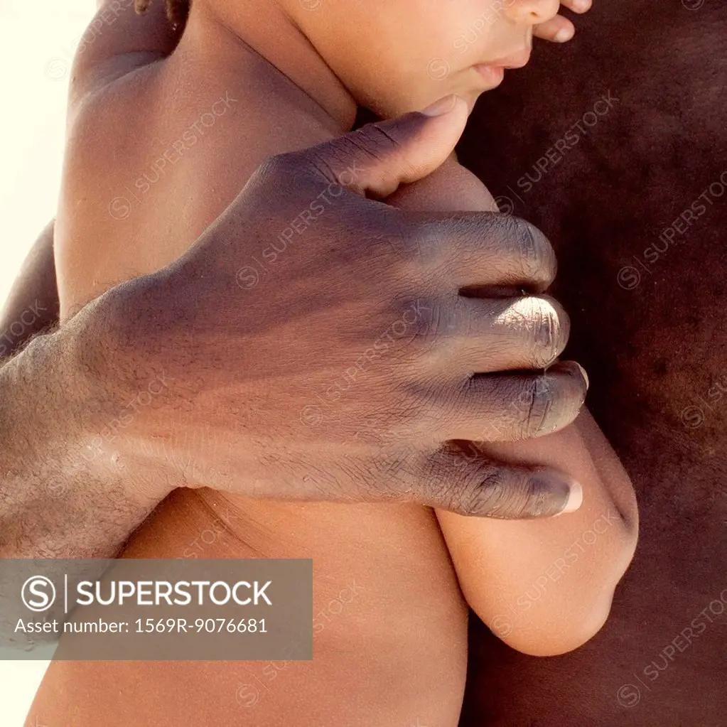 Father holding child, cropped