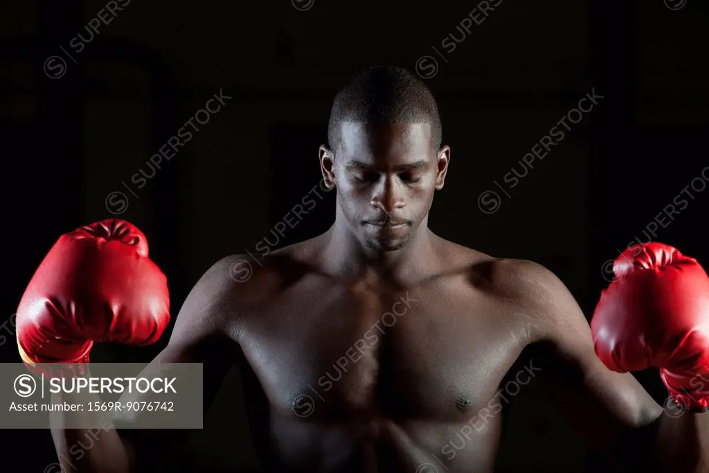 Boxer in boxing gloves with eyes closed, portrait