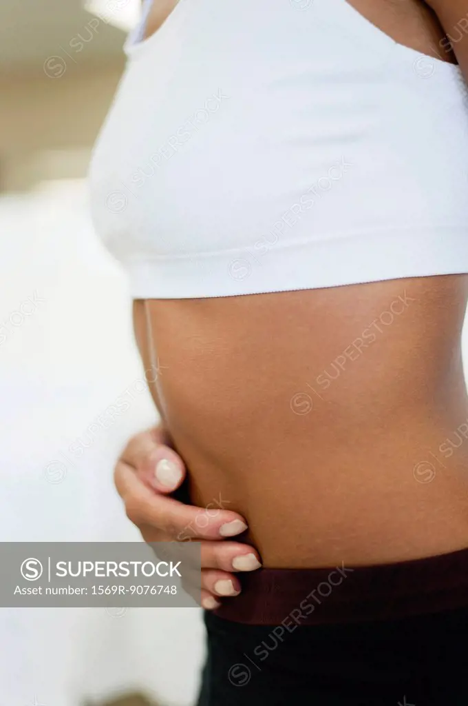 Woman holding stomach, mid section