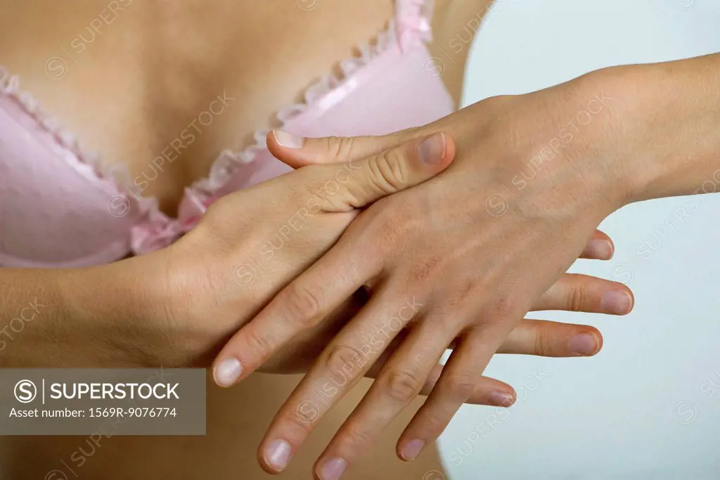 Woman rubbing hands, close_up