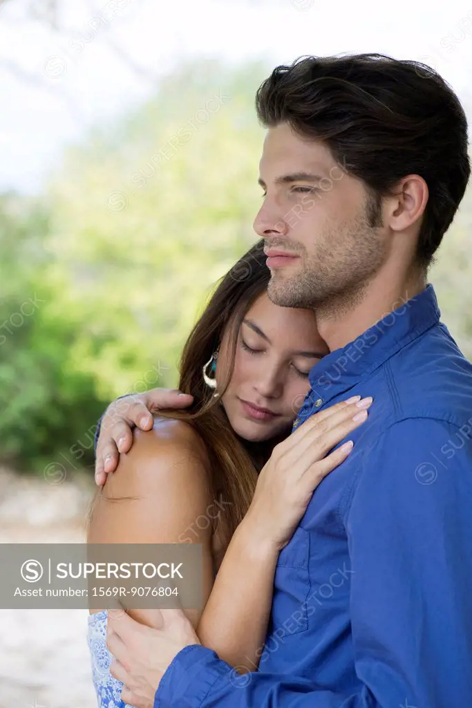 Young couple embracing, portrait