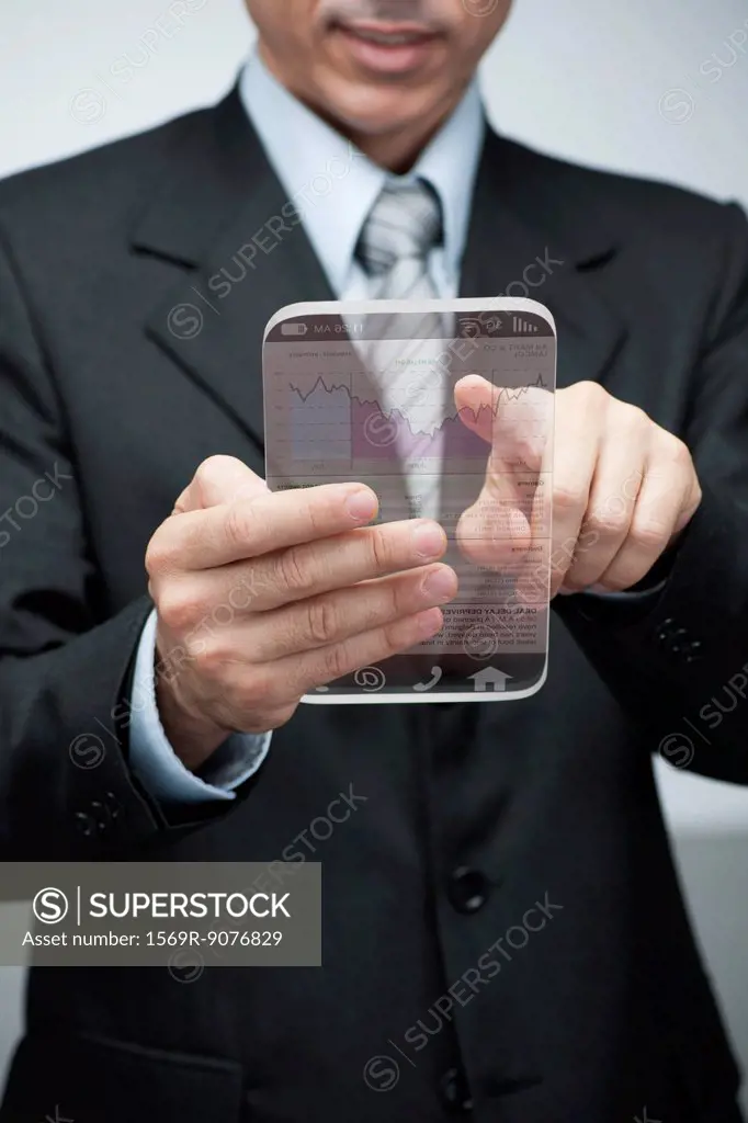 Businessman using advanced digital tablet to access stock market data, cropped