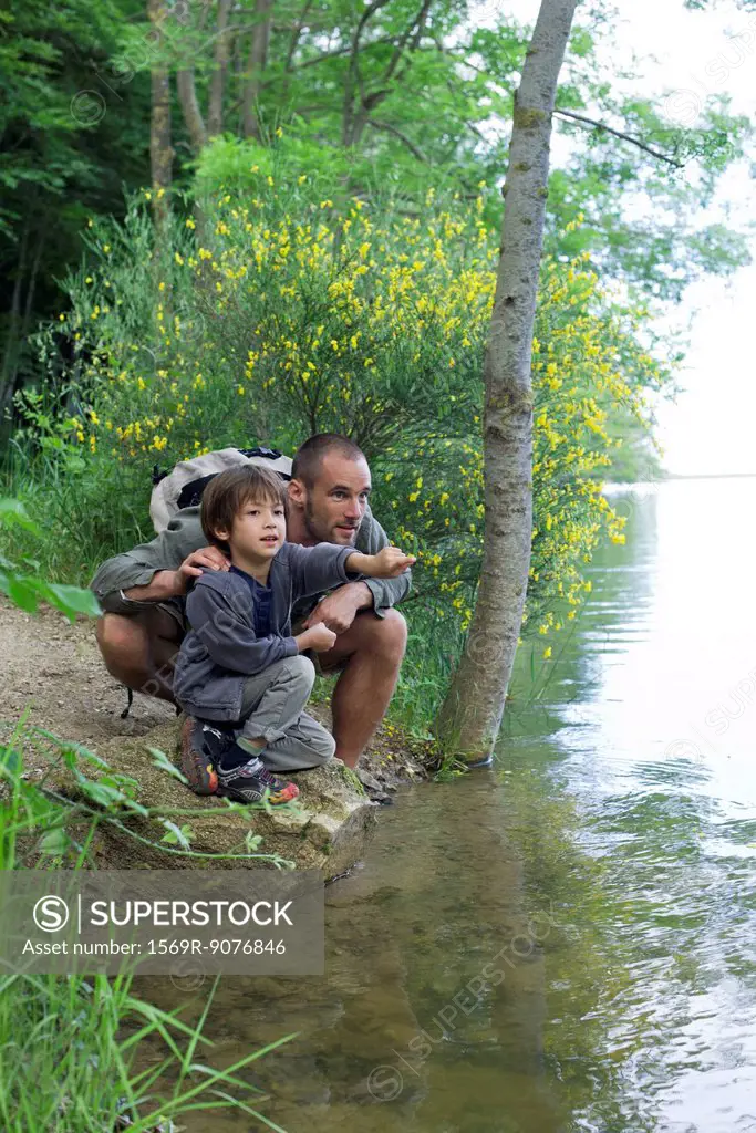 Father and son by river