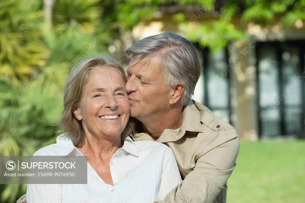 Senior man kissing his wife on the cheek