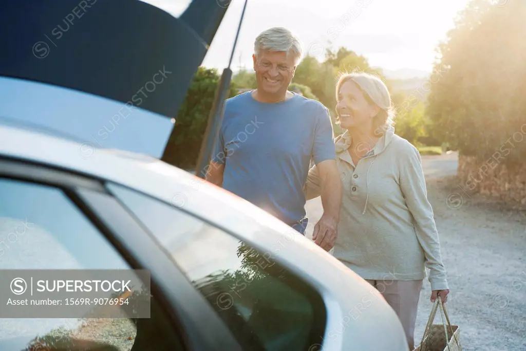 Senior couple loading car