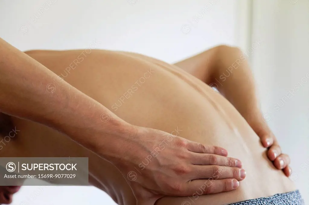Man experiencing lower back pain, cropped