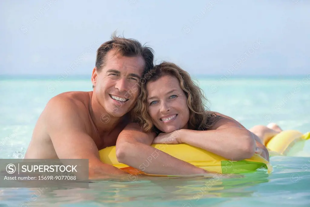 Couple relaxing in ocean, portrait