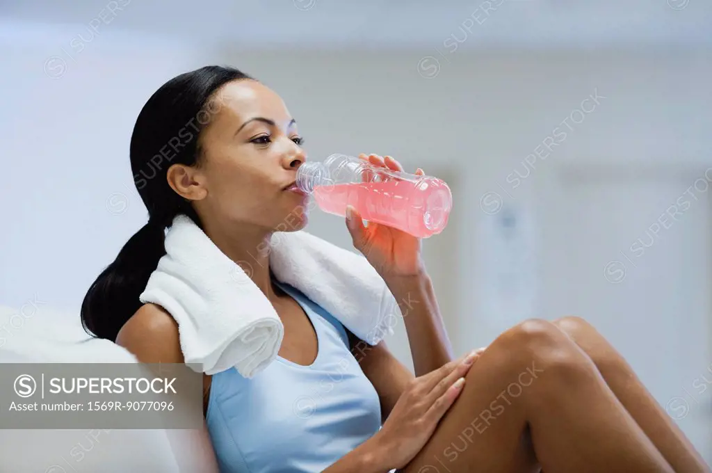 Young woman drinking sports drink