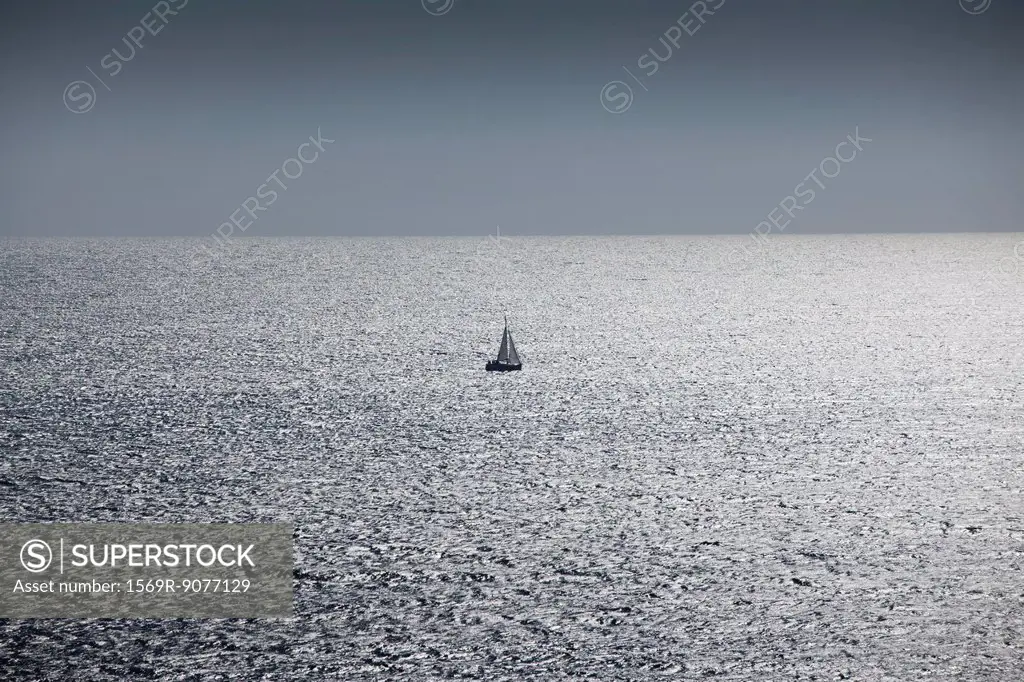 Solitary sailboat at sea