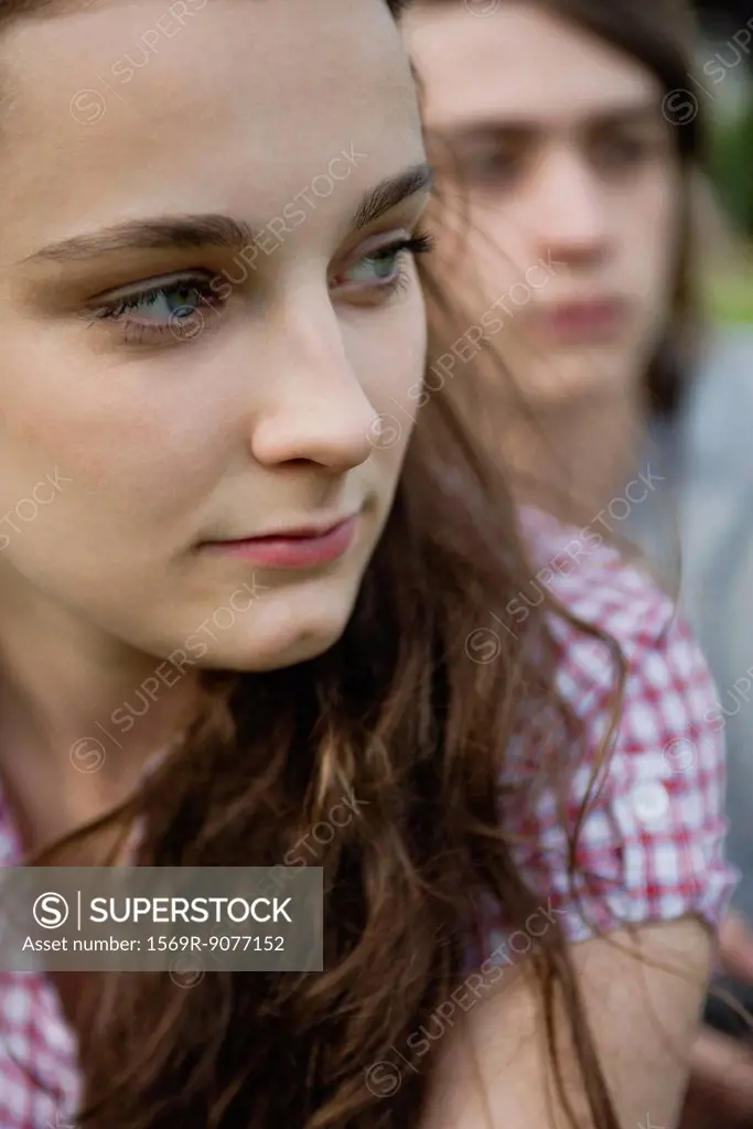 Young woman looking away in thought, portrait