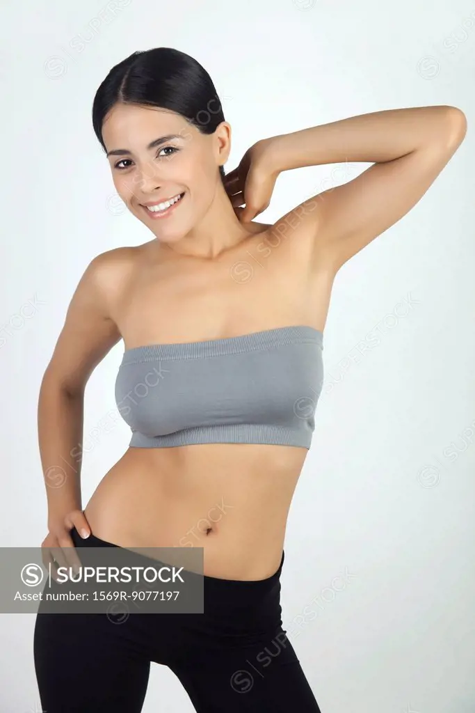 Woman wearing fitness clothing, smiling, portrait