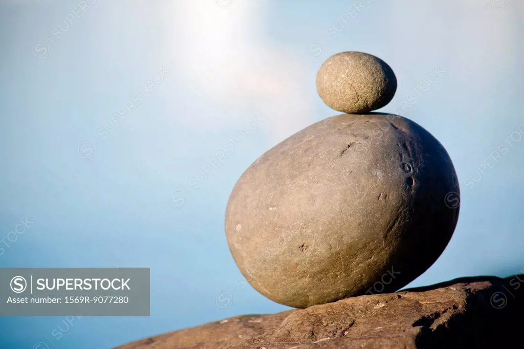 Small stone stacked on top of larger stone