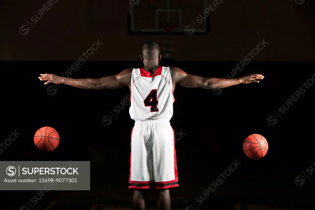 Basketball player dribbling two balls