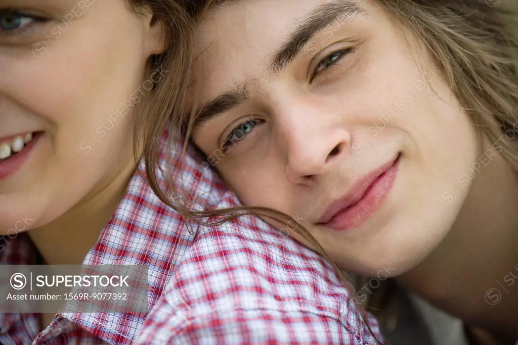 Young man resting head on girlfriend´s shoulder, cropped portrait