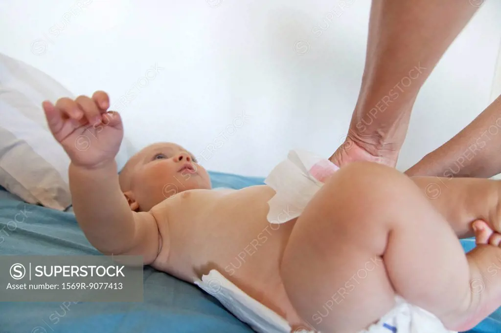 Baby having diaper changed, cropped