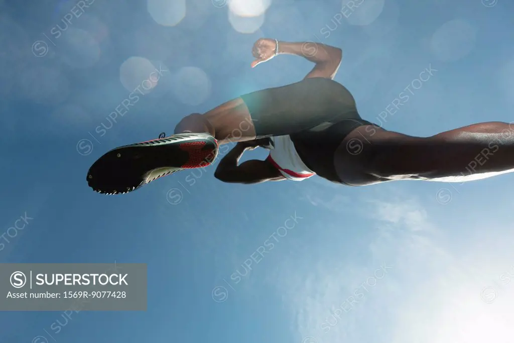 Athlete in midair, low angle view