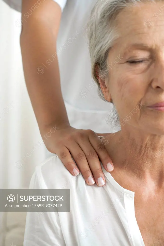 Senior woman getting a shoulder massage, cropped