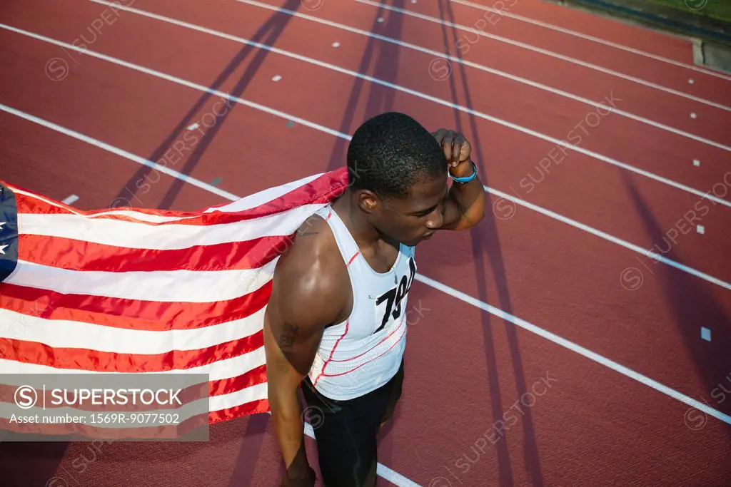 Runner holding up American flag after race