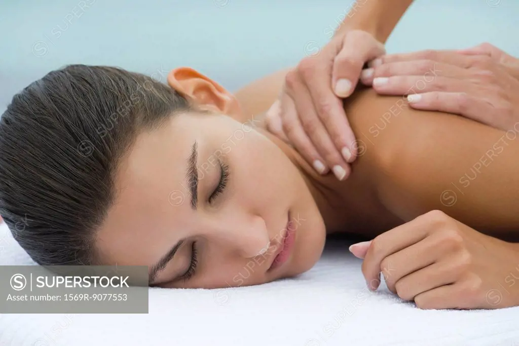 Young woman receiving back massage, cropped