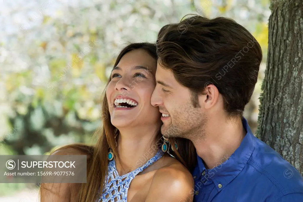Young couple laughing, portrait