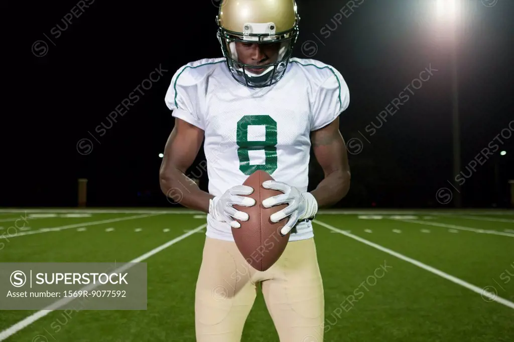 Football player holding football