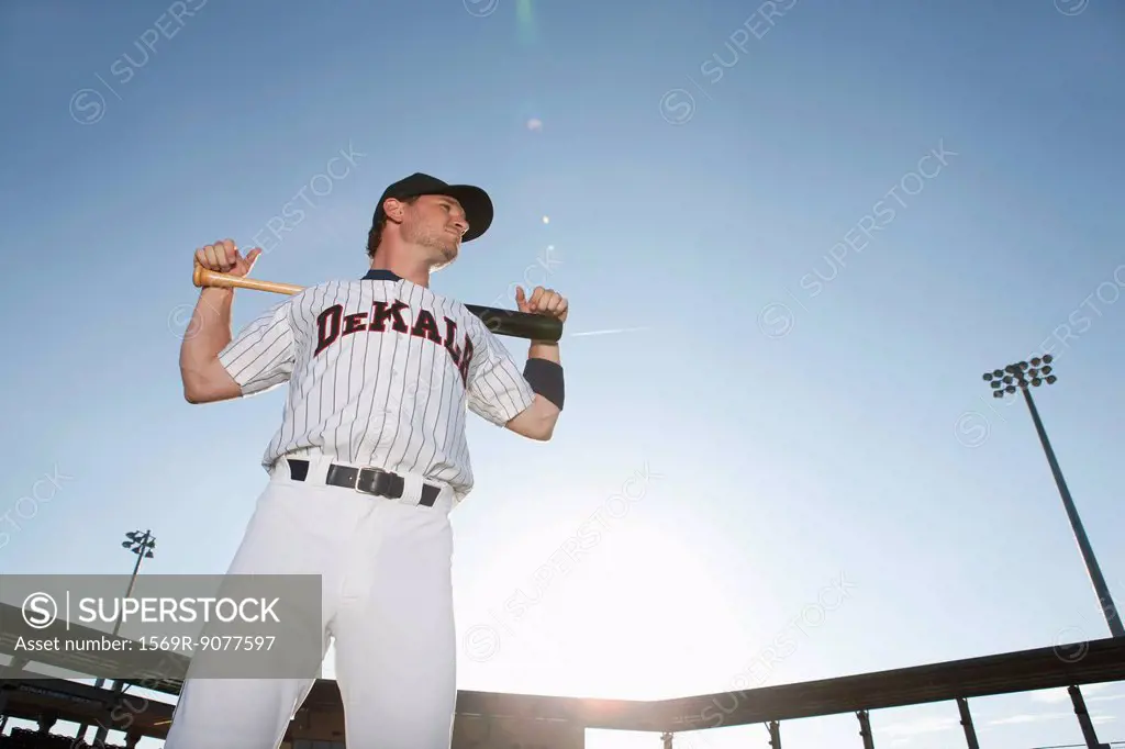 Baseball player holding bat across shoulders