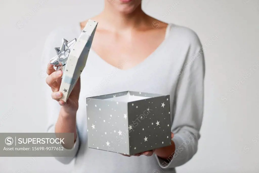 Woman opening gift box, cropped