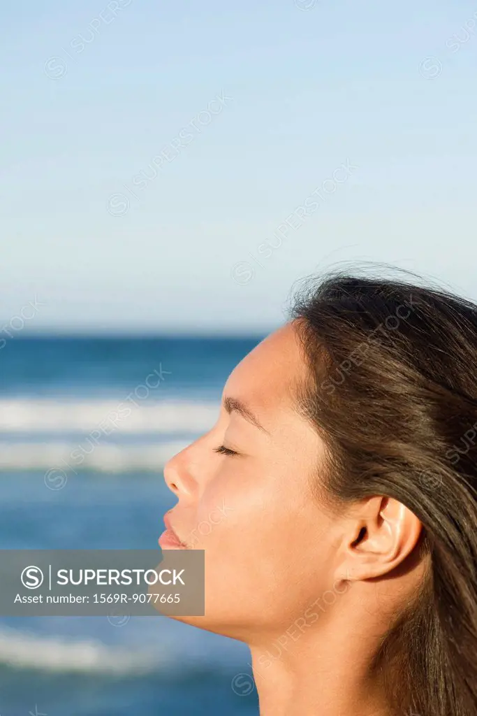 Young woman relaxing with eyes closed, profile