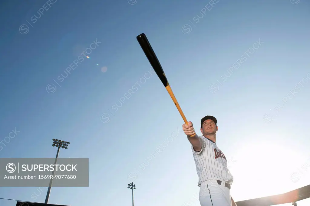 Baseball player holding out baseball bat
