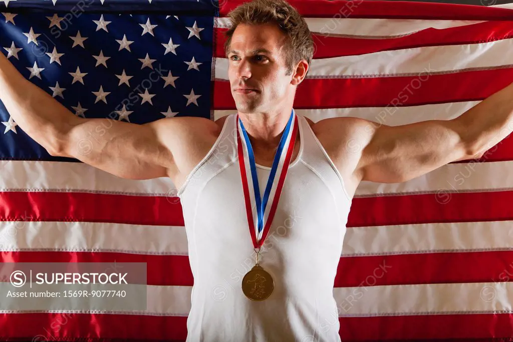 Male medalist in front of American flag