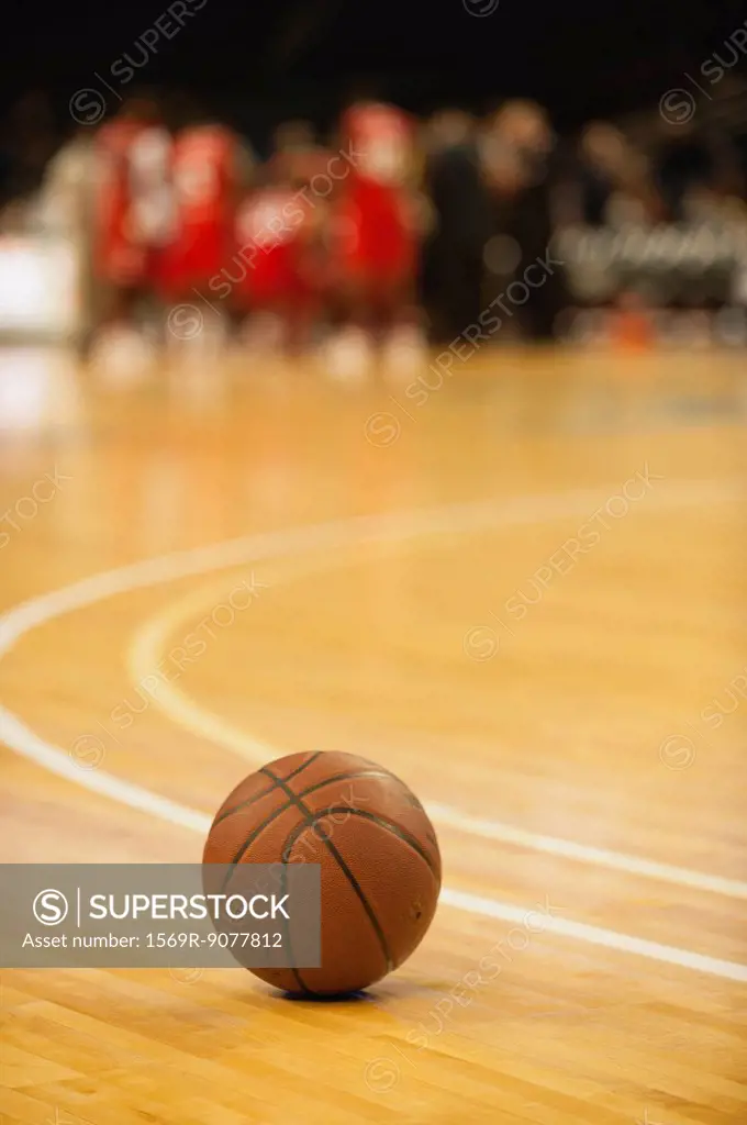 Basketball resting on court