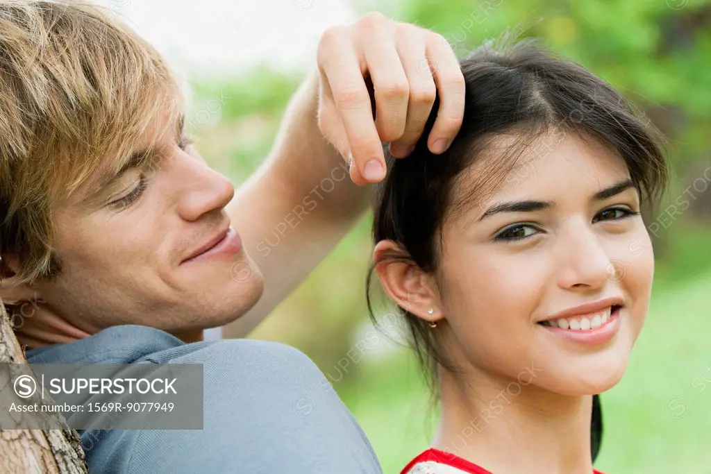Young couple together outdoors, portrait