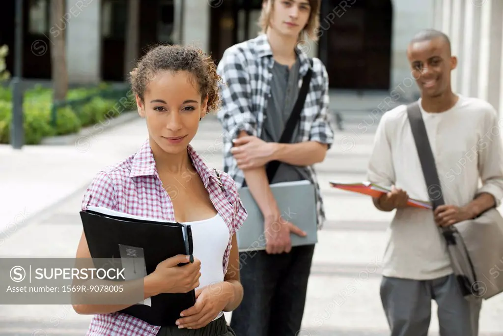 University students on campus, focus on woman in foreground