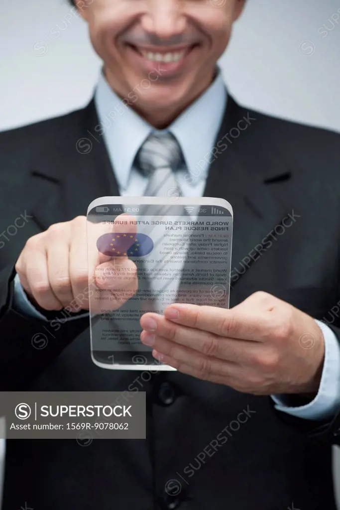 Businessman reading news on advanced digital tablet, cropped