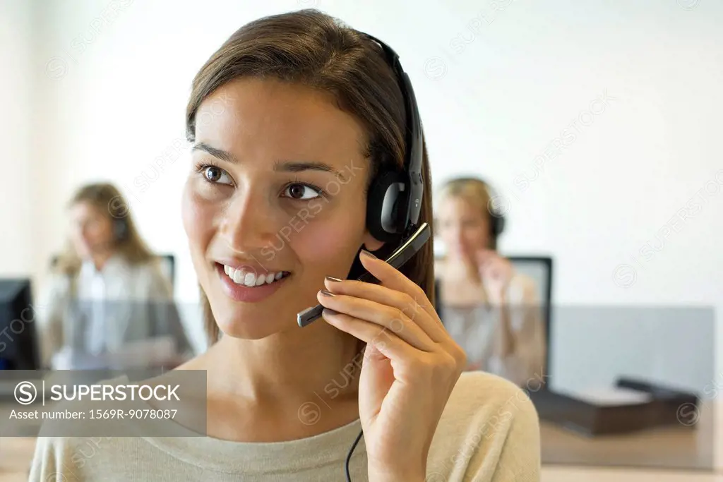 Woman using headset in office