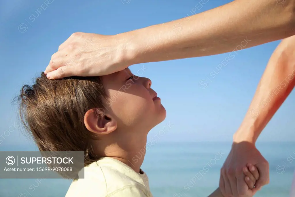 Mother´s hand on boy´s head