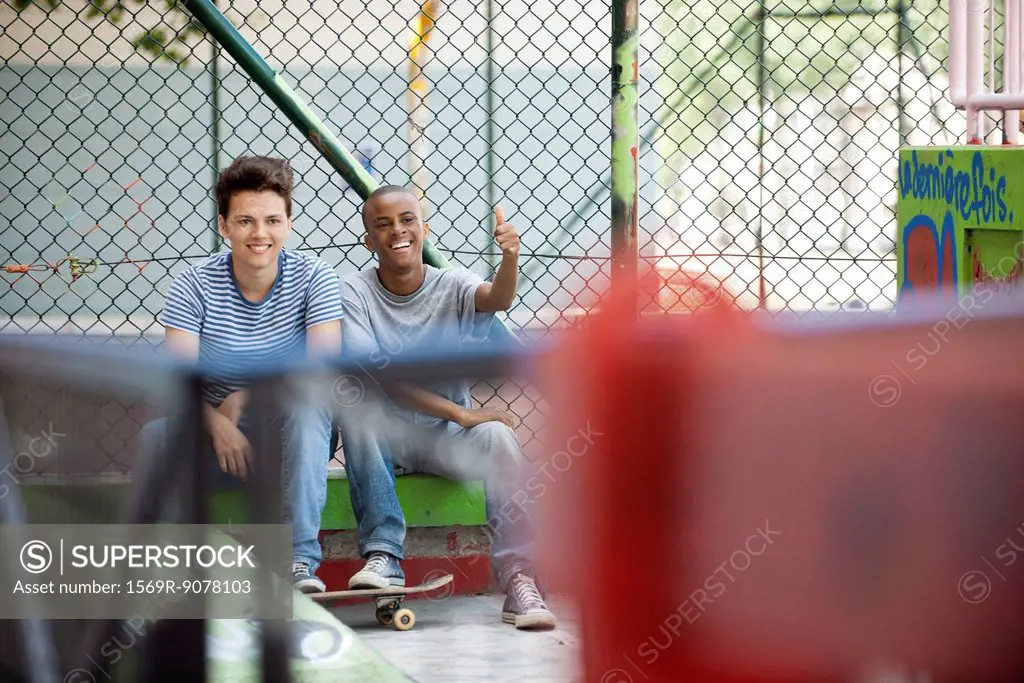 Young men hanging out in skateboard park