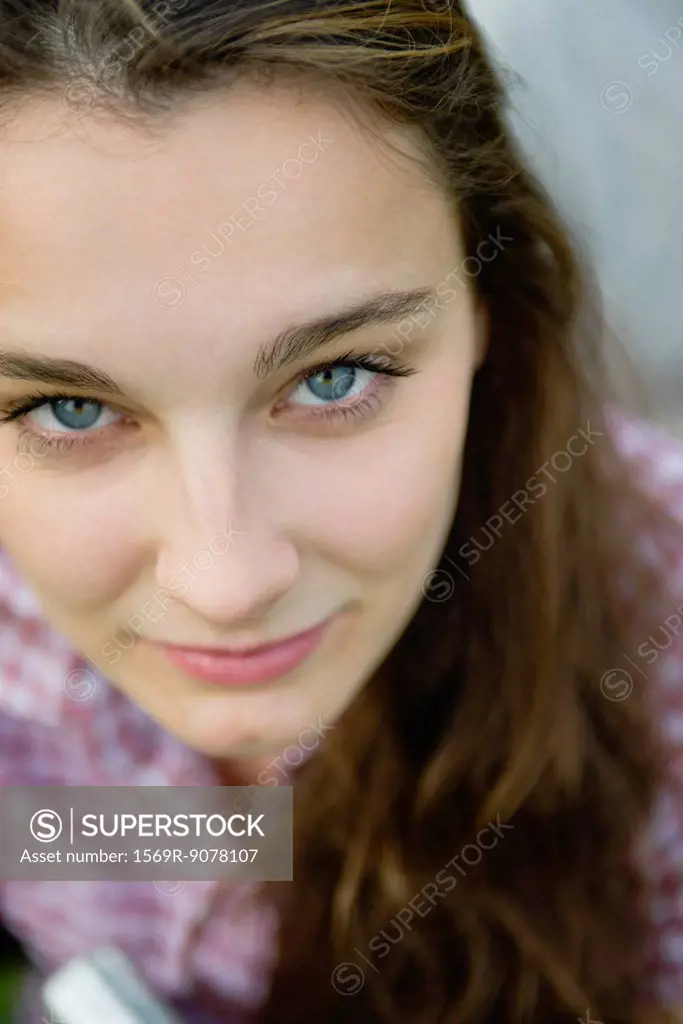 Young woman looking up at camera, portrait