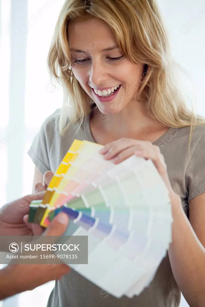 Young woman looking at paint swatches