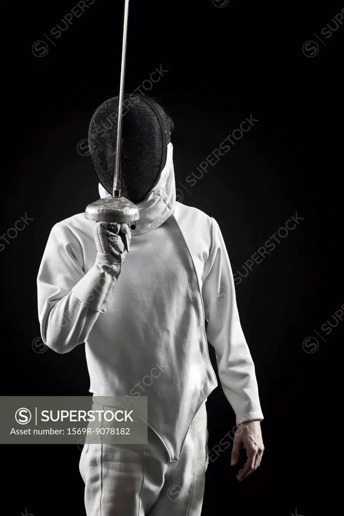 Fencer holding up foil, portrait
