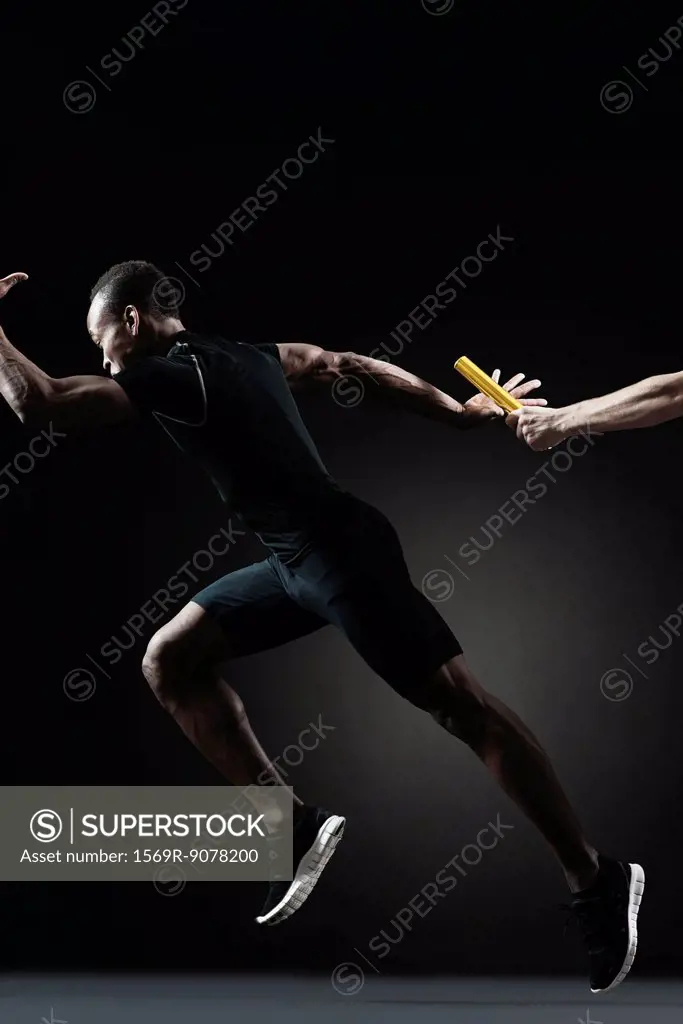 Runners passing baton