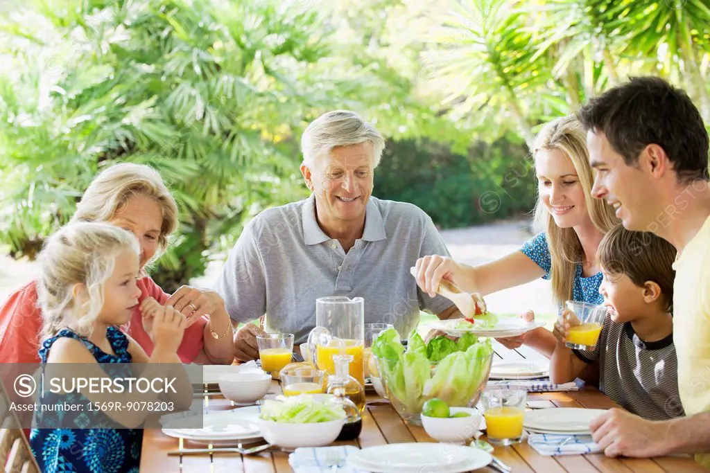 Multi_generation family having breakfast together outdoors